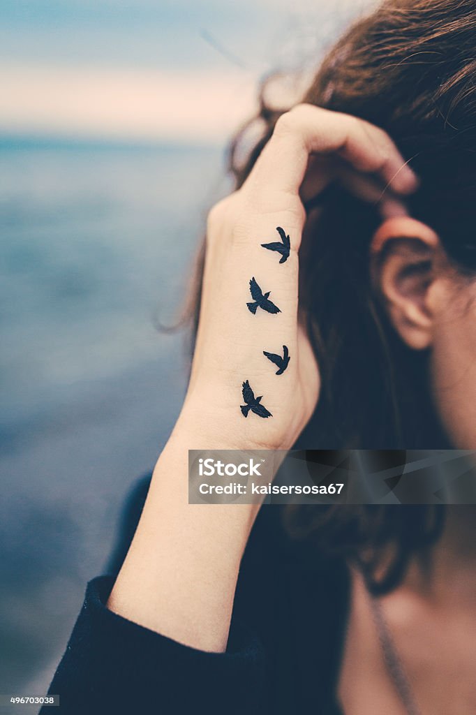 Girl With Birds Tattooed On The Hand Freedom Concept Stock Photo - Download  Image Now - iStock