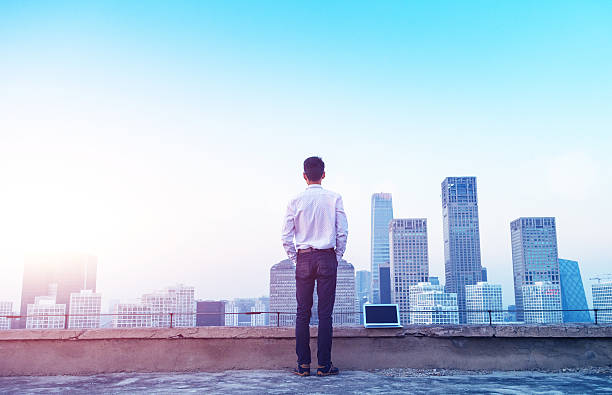 istock Businessman looking at cityscape with sunlight 496703066