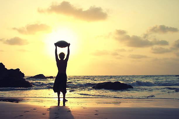 Hang drum misician on the sea shore on the sunset. stock photo