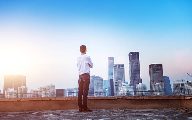 istock Businessman looking at cityscape with sunlight 496703420