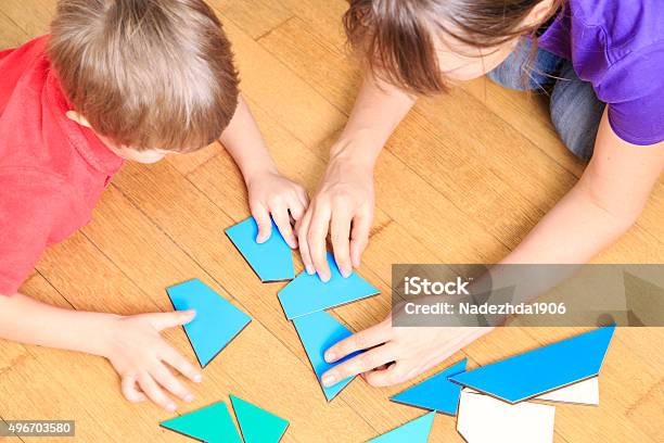 Hands Of Teacher And Child Playing With Geometric Shapes Stock Photo - Download Image Now