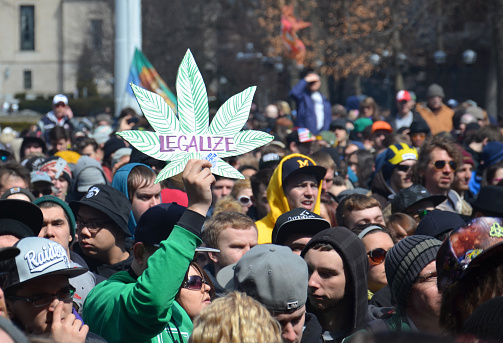 Ann Arbor, MI, USA - April 5, 2014: A participant holds up a sign at the 43rd annual Hash Bash rally in Ann Arbor, MI April 5, 2014.