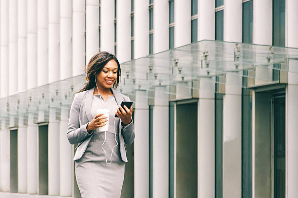 Portrait Of Successful Businesswoman During Coffee Break Portrait of successful businesswoman during coffee break holding a cup of freshly brewed coffee and talking on the phone. cityscape videos stock pictures, royalty-free photos & images