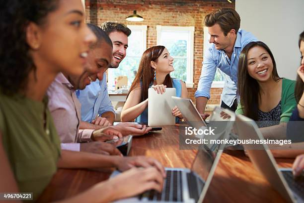 Group Of Business People Meeting Around Table Stock Photo - Download Image Now - Business Meeting, Teamwork, 20-29 Years