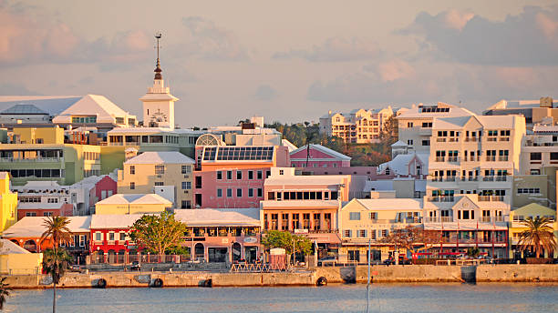 Hamilton, Bermuda... Sunset on the waterfront and Front Street. From the bay, a view of the capital city, Hamilton, Bermuda at sunset. bermuda stock pictures, royalty-free photos & images