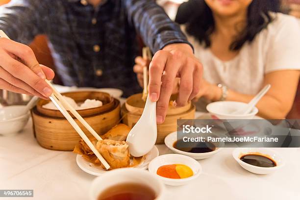 Asian Diners Enjoying Dim Sum Stock Photo - Download Image Now - Restaurant, Chinese Food, Eating