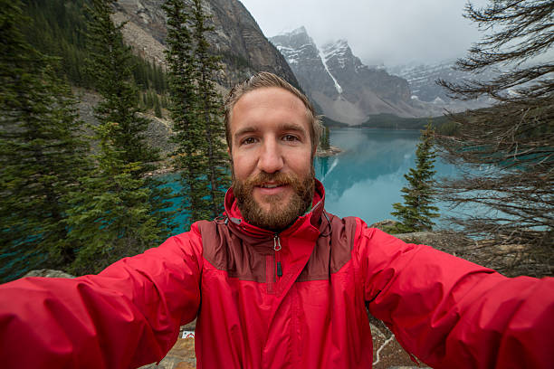 istock One man at Moraine lake taking a selfie portrait 496707024