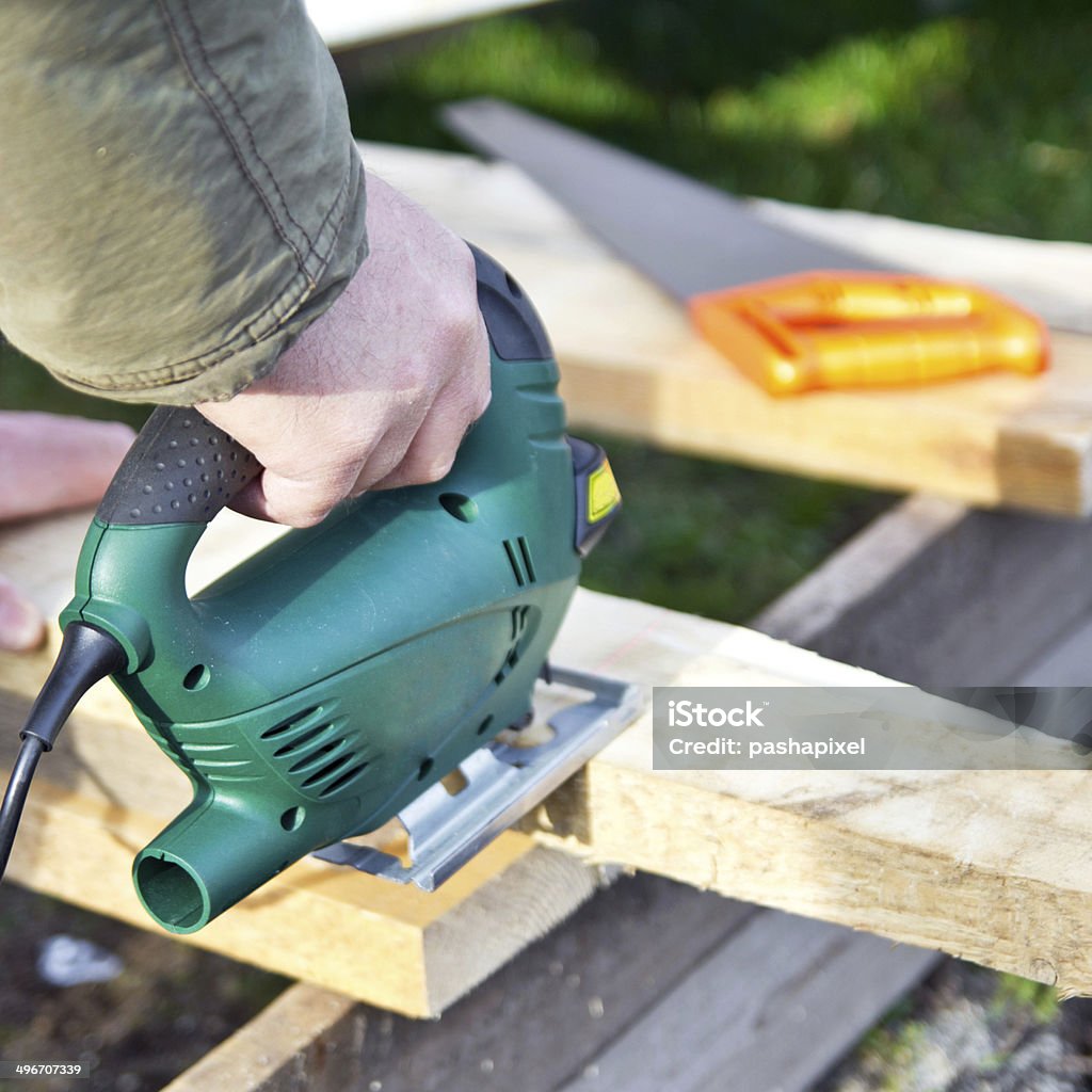 Fretsaw in hand Fretsaw in hand, sawing pine plank Accuracy Stock Photo