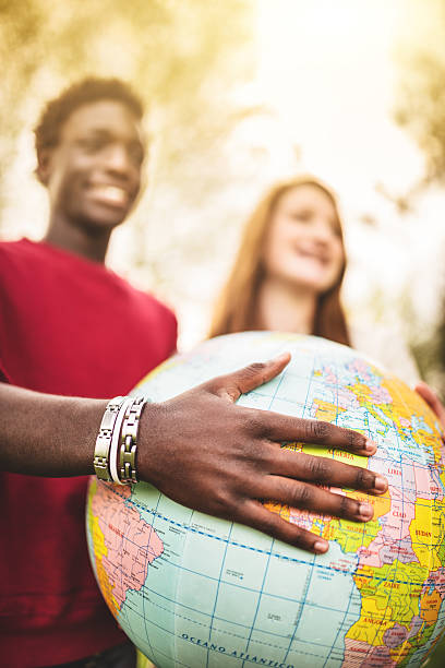 istock teenagers college student smiling with globe 496707367