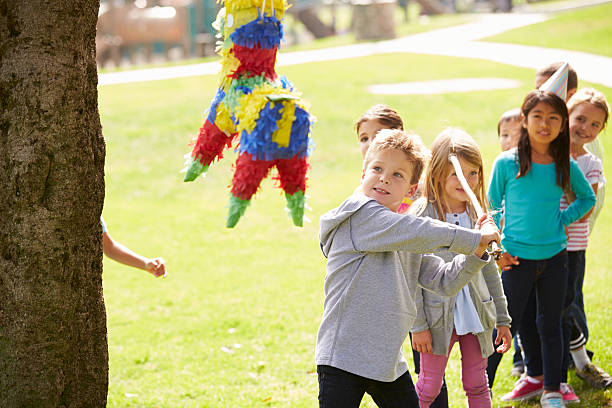 istock Children Hitting Pinata At Birthday Party 496707377