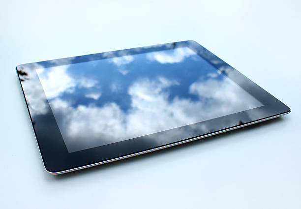 istock Image of tablet computer, reflections of sky on glass screen 496707483