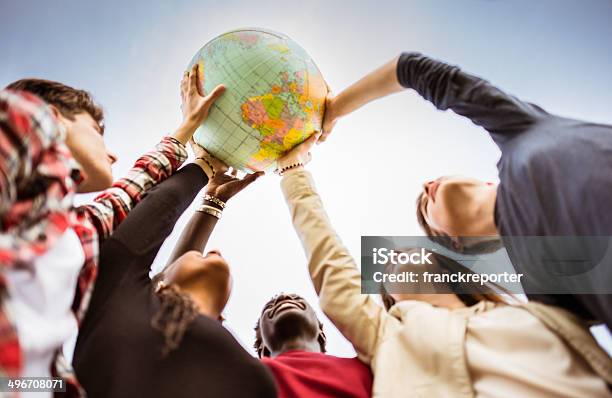 Teenagers Reaching The World At Campus Stock Photo - Download Image Now - Globe - Navigational Equipment, Global, Teenager