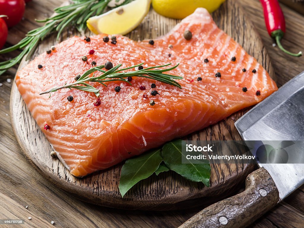 Fresh salmon on the cutting board. Fresh salmon on the cutting board. Cooking process. Fish Stock Photo