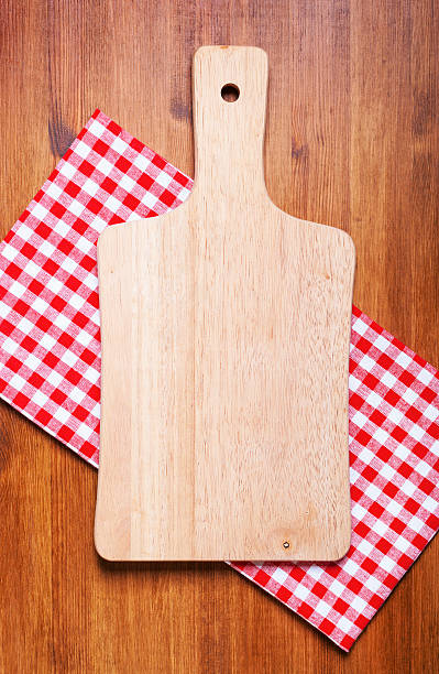 istock Kitchen cutting board and a towel on the wooden table 496713620