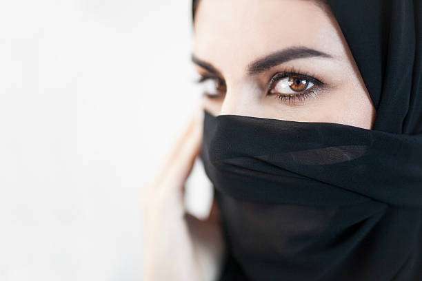 istock Emirati Woman Gaze with Her Face Covered 496713968