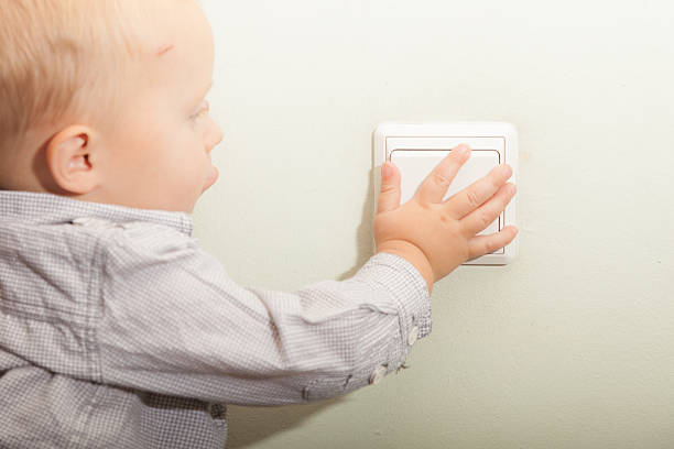istock Baby boy child kid turning on the light. 496718291