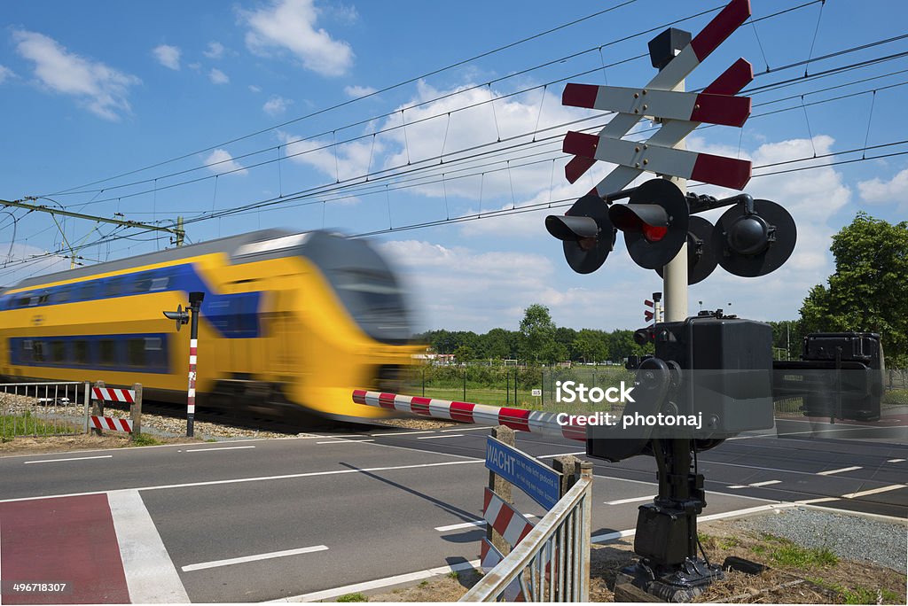 Train riding over a rail crossing in spring Activity Stock Photo