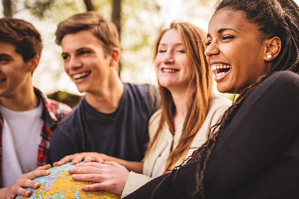 istock teenagers college student smiling with globe 496719323