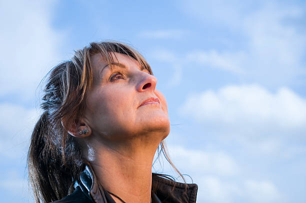 mature woman look in the sky stock photo