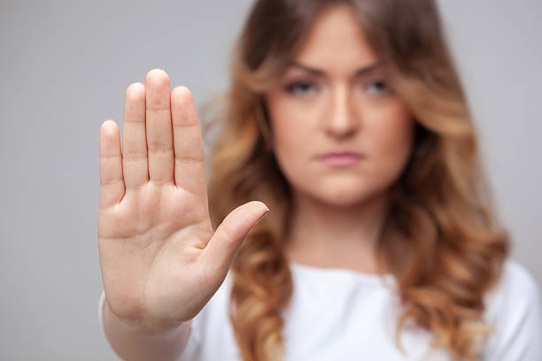 istock female hand stop sign 496722181