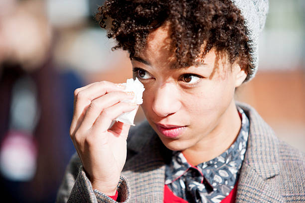 Sad girl Close up of a sad multi-racial girl in the streets of London. Image taken with Canon EOS 1 Ds Mark II and EF 70-200 mm USM L. Istockalypse London 2013. wiping tears stock pictures, royalty-free photos & images