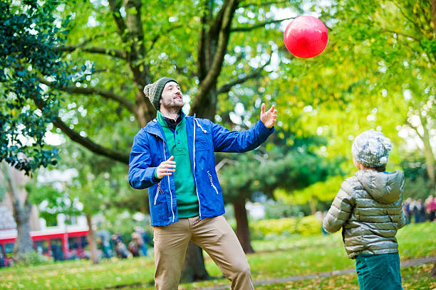 istock Father and daughter playing in a London`s park 496722791