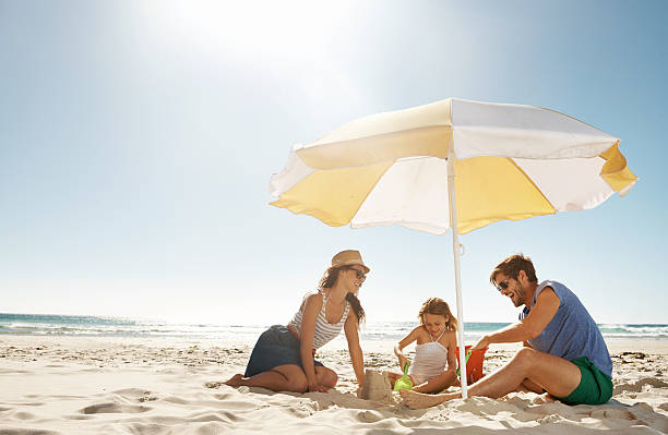 Family is everything Shot of a happy young family playing together on the beachhttp://195.154.178.81/DATA/i_collage/pu/shoots/784349.jpg beach stuff stock pictures, royalty-free photos & images