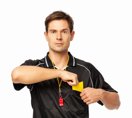 Portrait of confident soccer referee removing yellow card from pocket isolated over white background. Horizontal shot.
