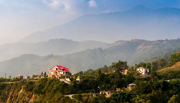 houses surrounded by hills and plants in himachal in India. Baijnath is a great place for travel and exploration