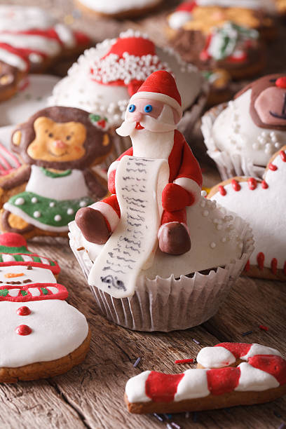 istock Christmas cupcakes and gingerbread macro on a wooden table. Vert 496727314