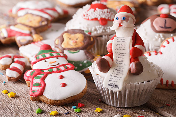 istock Christmas cupcakes and gingerbread macro on a wooden table. hori 496727496