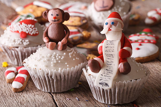 istock Christmas cupcakes decorated with figures of Santa and monkey cl 496728072