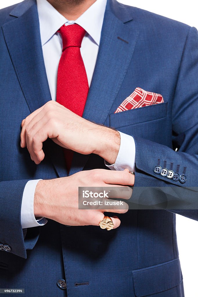 Elegant businessman wearing suit Portrait of elegant businessman wearing suit. Standing against white background. Studio shot, unrecognizable person. Close up of torso and hands. 2015 Stock Photo
