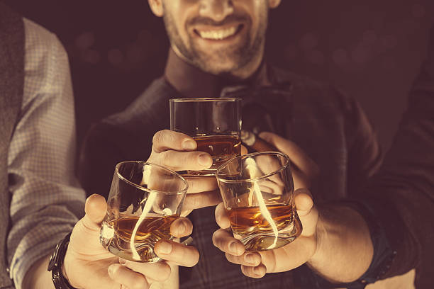 istock Men drinking whiskey, close up of glasses and hands 496732516