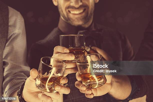 Men Drinking Whiskey Close Up Of Glasses And Hands Stock Photo - Download Image Now