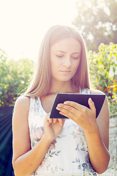 Young Woman, Girl Working With Tablet in Green Field, Park Young woman girl working with tablet in green field park with sunshine henry ford museum stock pictures, royalty-free photos & images