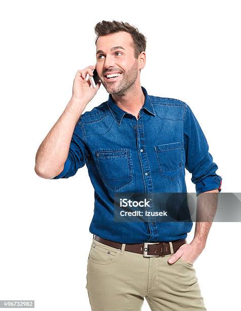 Happy Man Wearing Jeans Shirt Talking On Cell Phone Stock Photo - Download Image Now