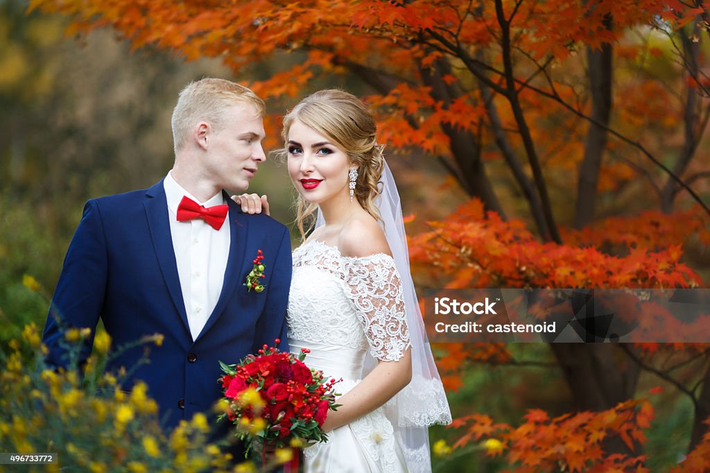 Happy couple in autumn forest Portrait of the wedding couple in autumn forest Wedding Stock Photo