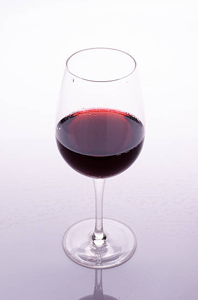 istock Red wine in a glass on white background 496734128