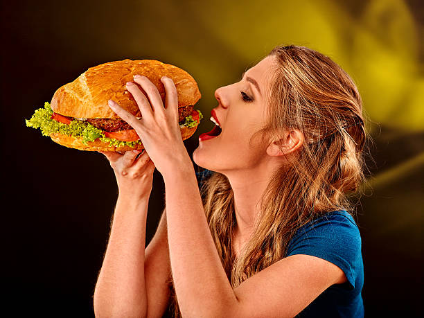 Girl eating big sandwich stock photo