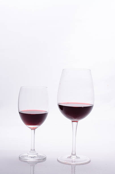 istock Red wine in a glass on white background 496734626