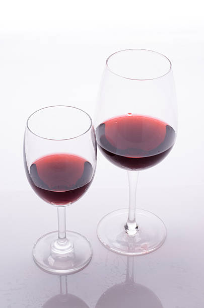 istock Red wine in a glass on white background 496734860