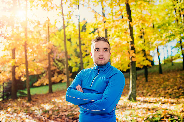 Young handsome runner Young handsome runner outside in sunny autumn nature beautiful multi colored tranquil scene enjoyment stock pictures, royalty-free photos & images