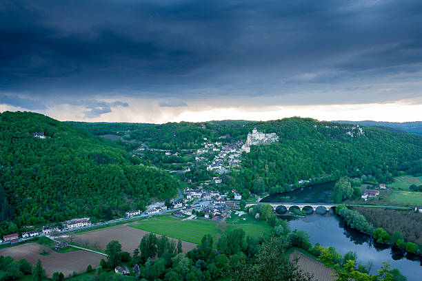 Village and Chateau Castlenaud with a stormy sky Dordogne France