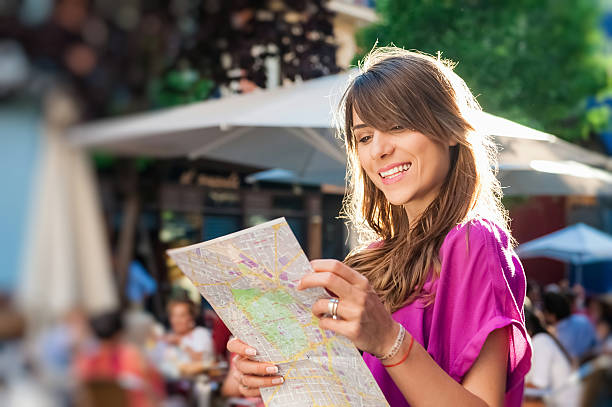 istock Woman tourist holding a paper map 496738936