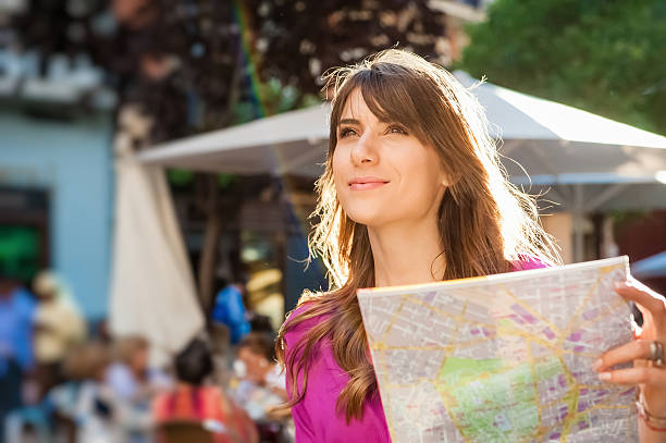 istock Woman tourist holding a paper map 496738992