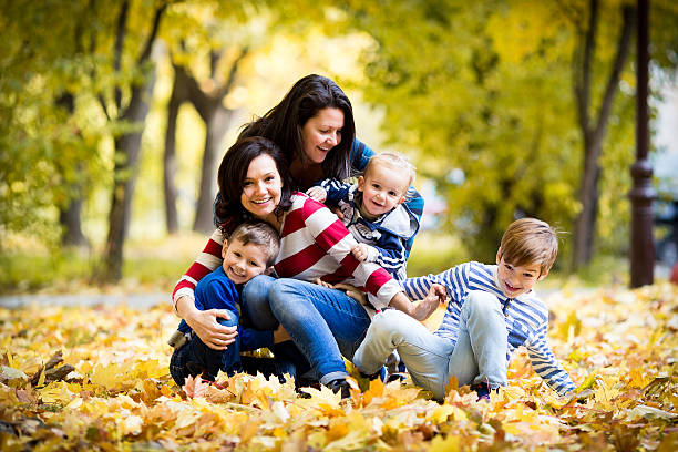 istock Happy young mothers and their three kids Autumn fall colours 496740734