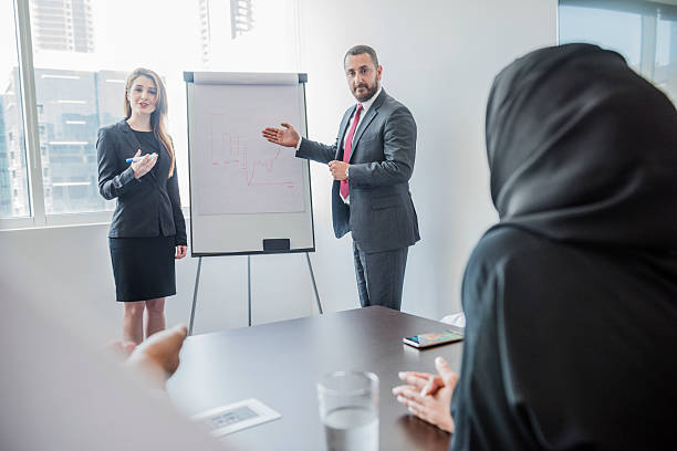 istock Businessman and woman using flipchart in meeting presentation 496767982