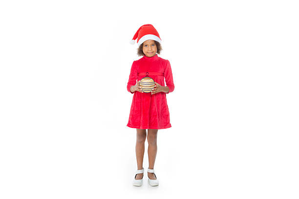 little child with a christmas ball smile and looking at the camera