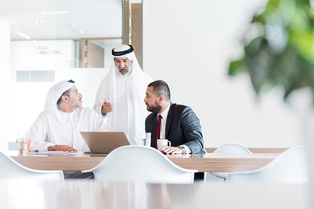 tres hombres de negocios árabe en reunión de negocios en la oficina moderna - arabia fotografías e imágenes de stock